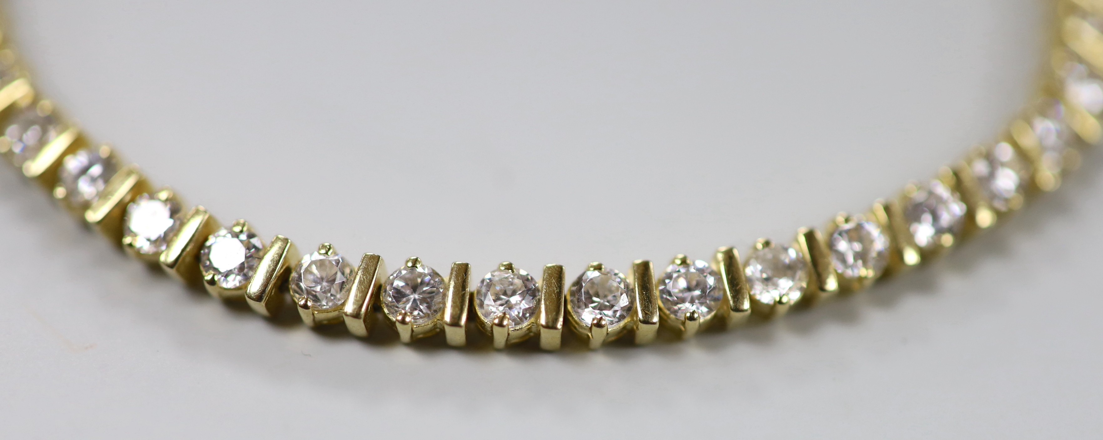 A modern 14k yellow metal and simulated diamond set line bracelet, 18cm and a 14k yellow metal and white opal set line bracelet, 18.5cm, gross weight 19.5 grams.